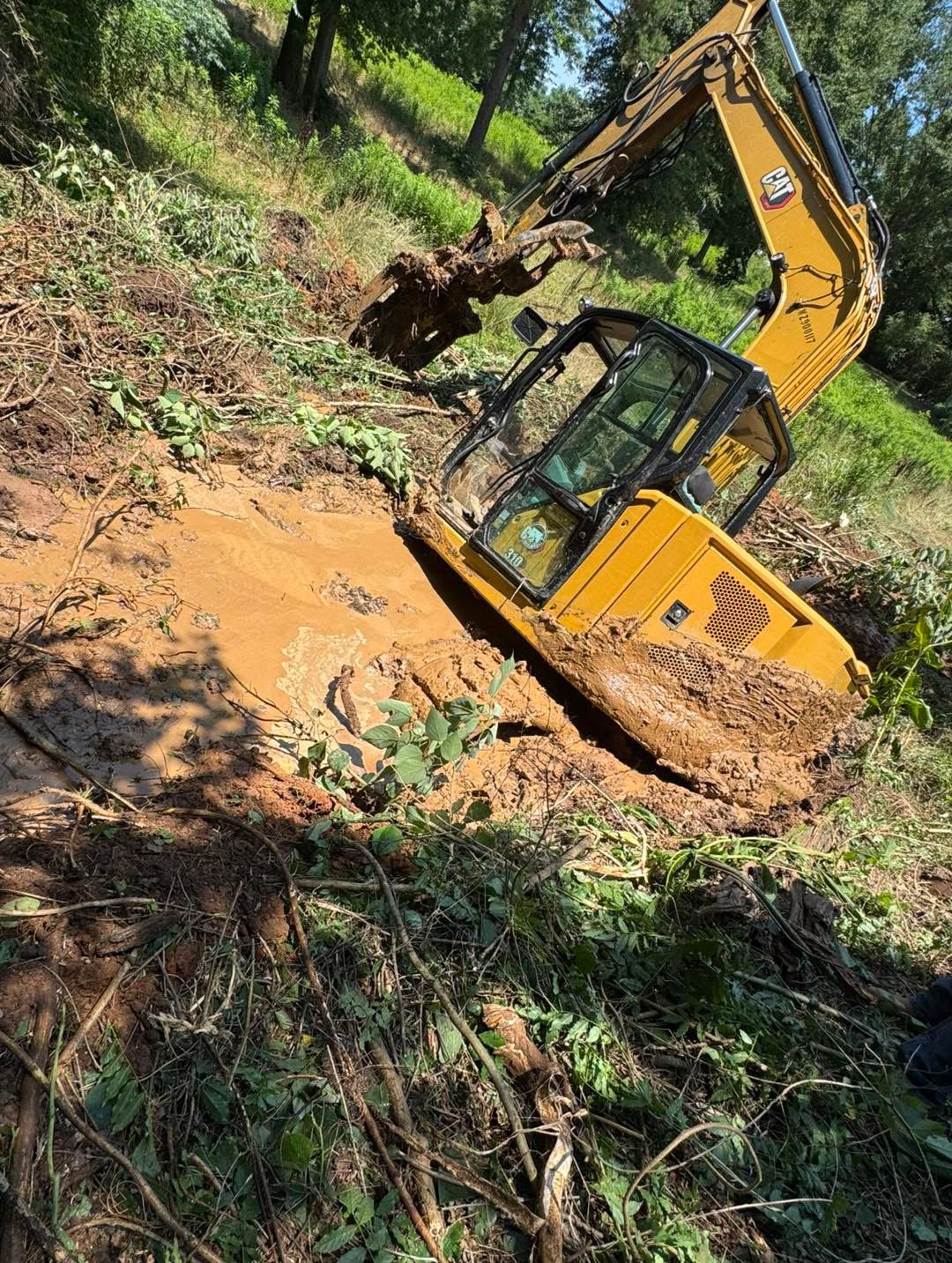 Excavator addressing drainage on a Mississippi property